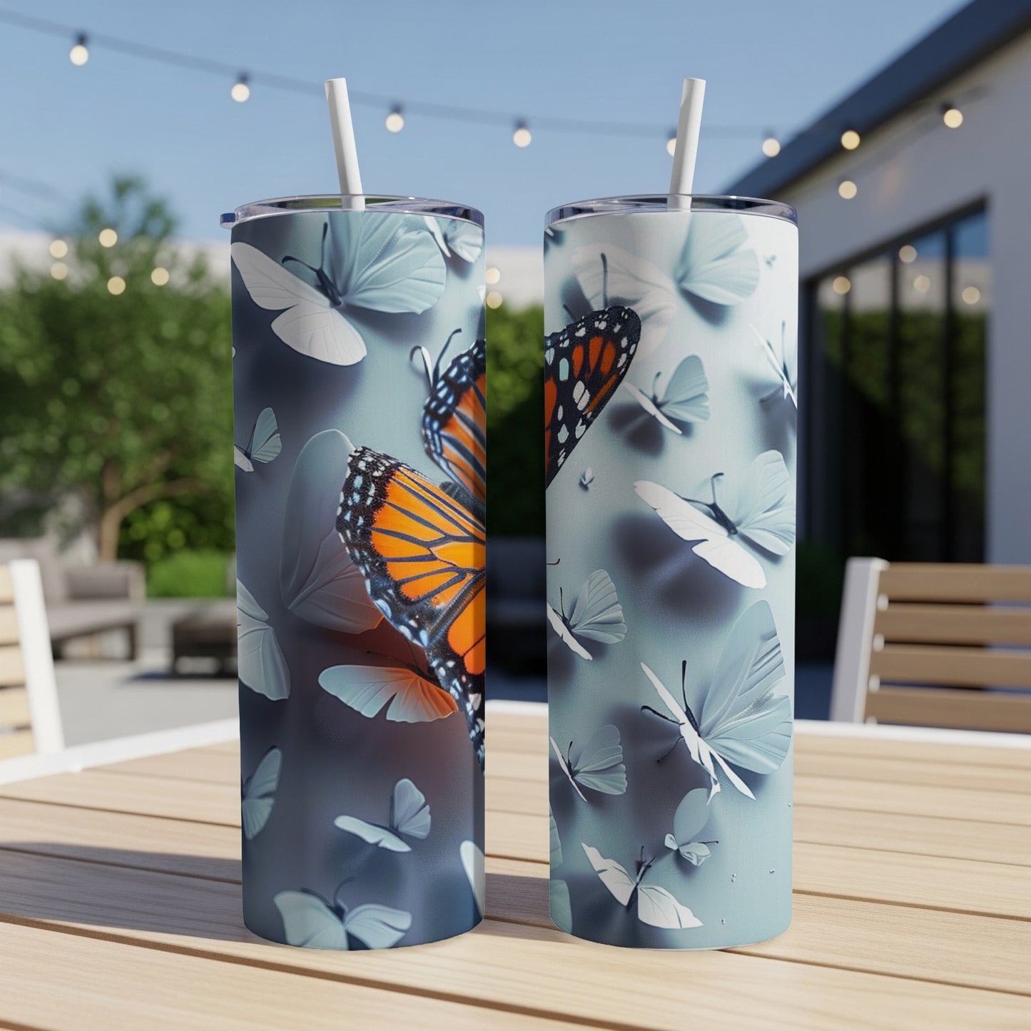Two tumblers with monarch butterfly and white butterfly designs.