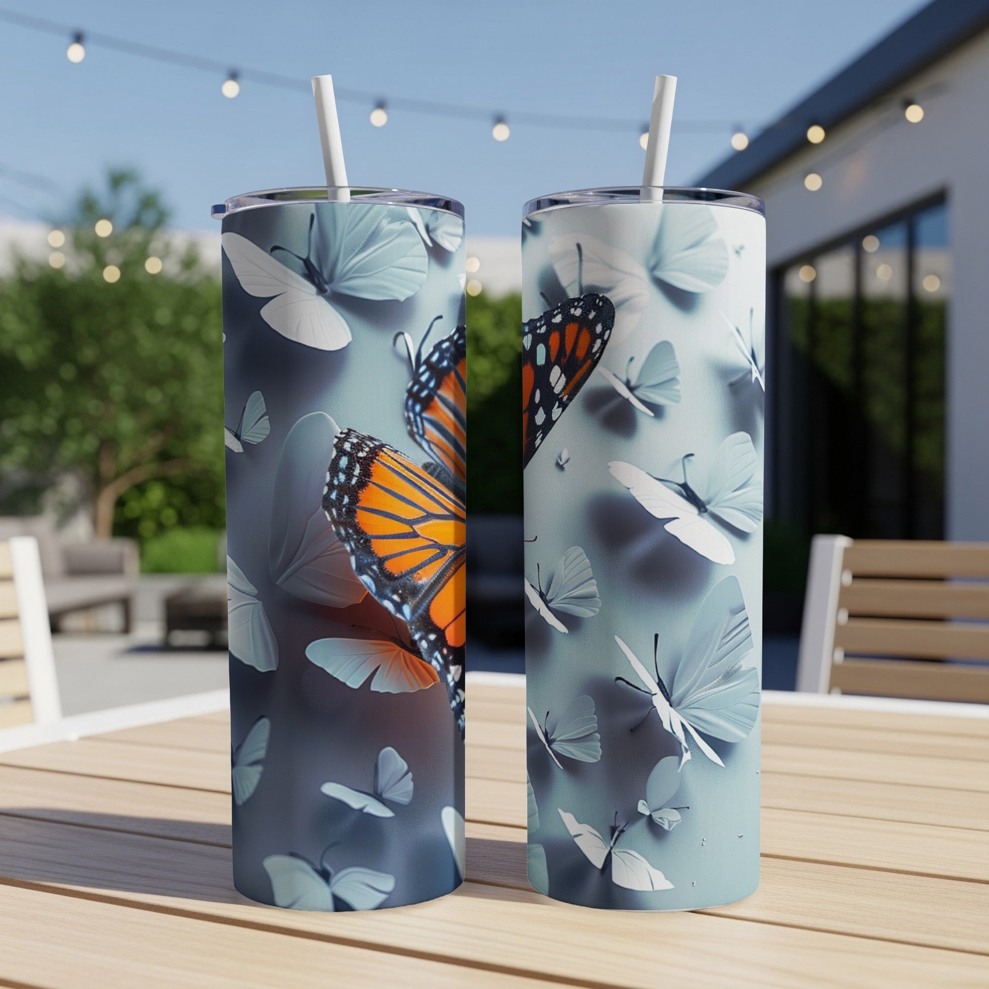 Two tumblers with monarch butterfly and white butterfly designs.