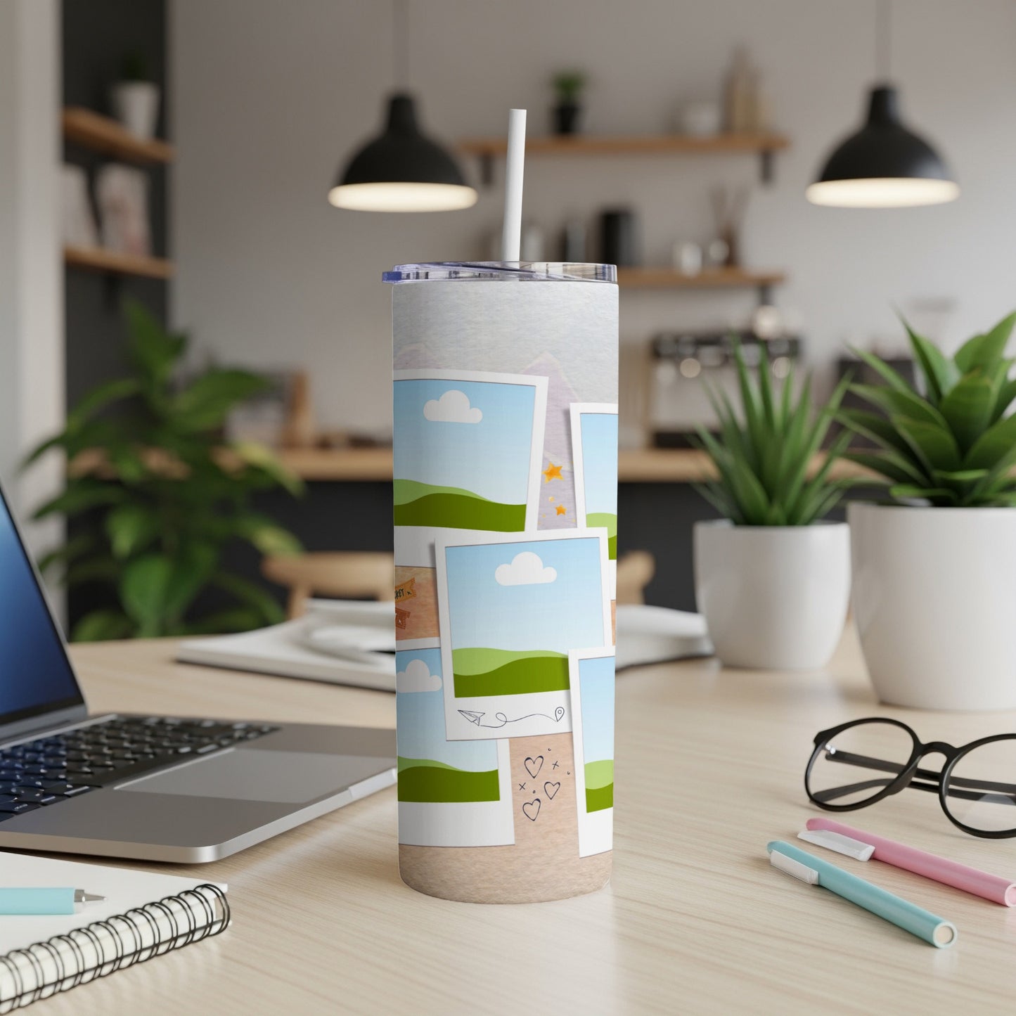 Tumbler with travel photo collage and straw on a desk.