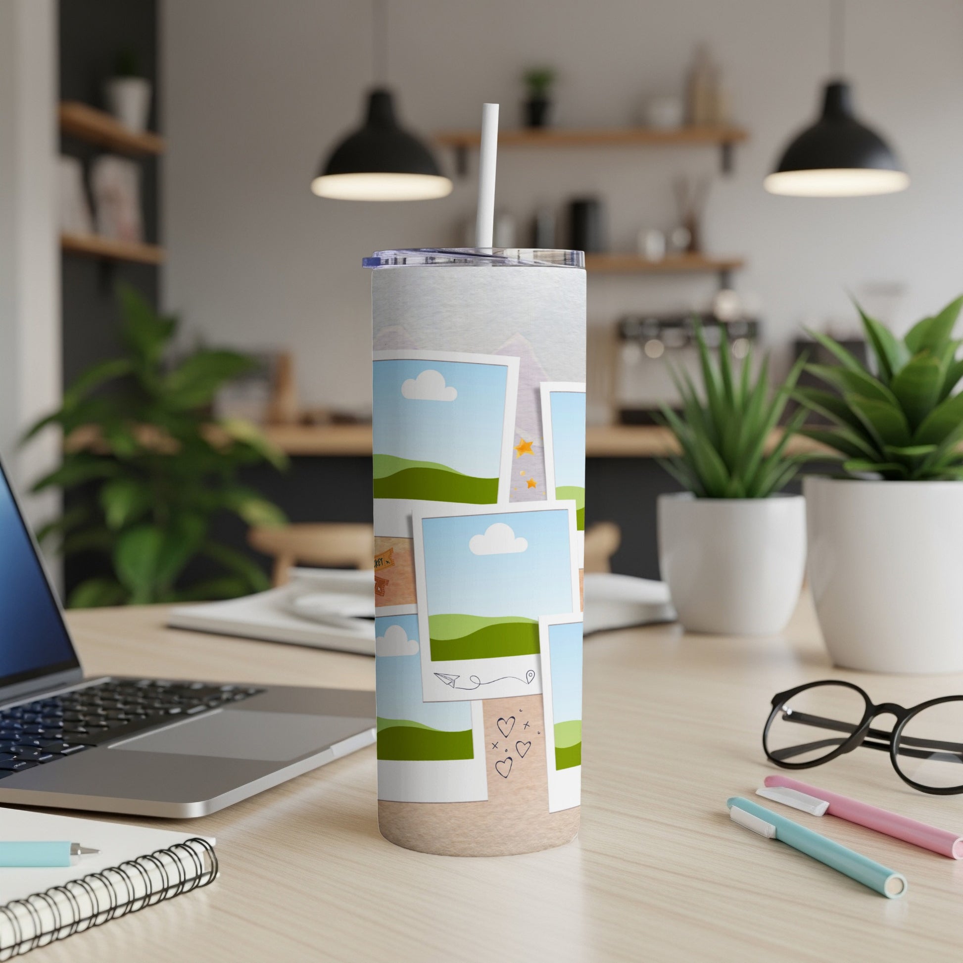 Tumbler with travel photo collage and straw on a desk.