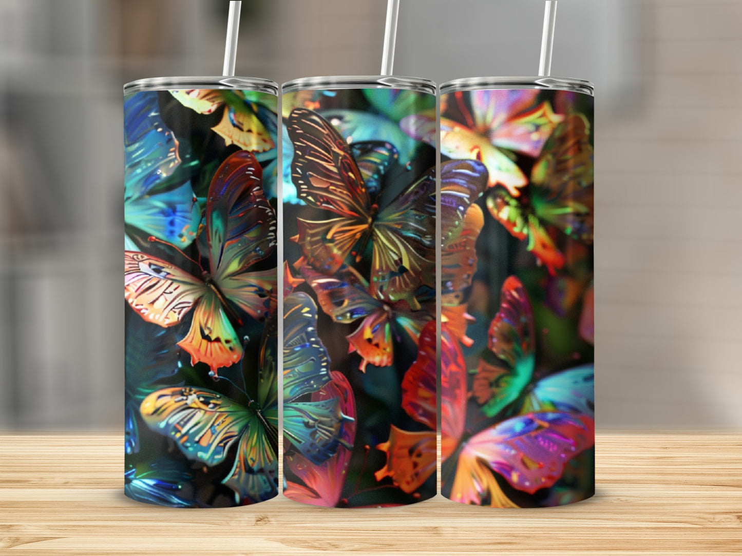 Three tumblers with a colorful, abstract butterfly pattern.