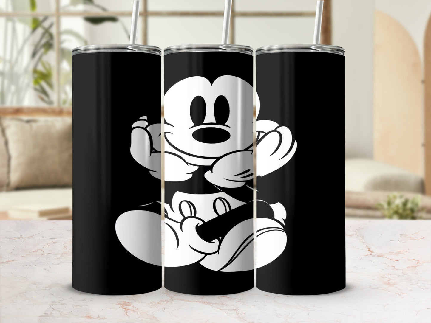 Black tumbler with white Mickey Mouse design and straw.