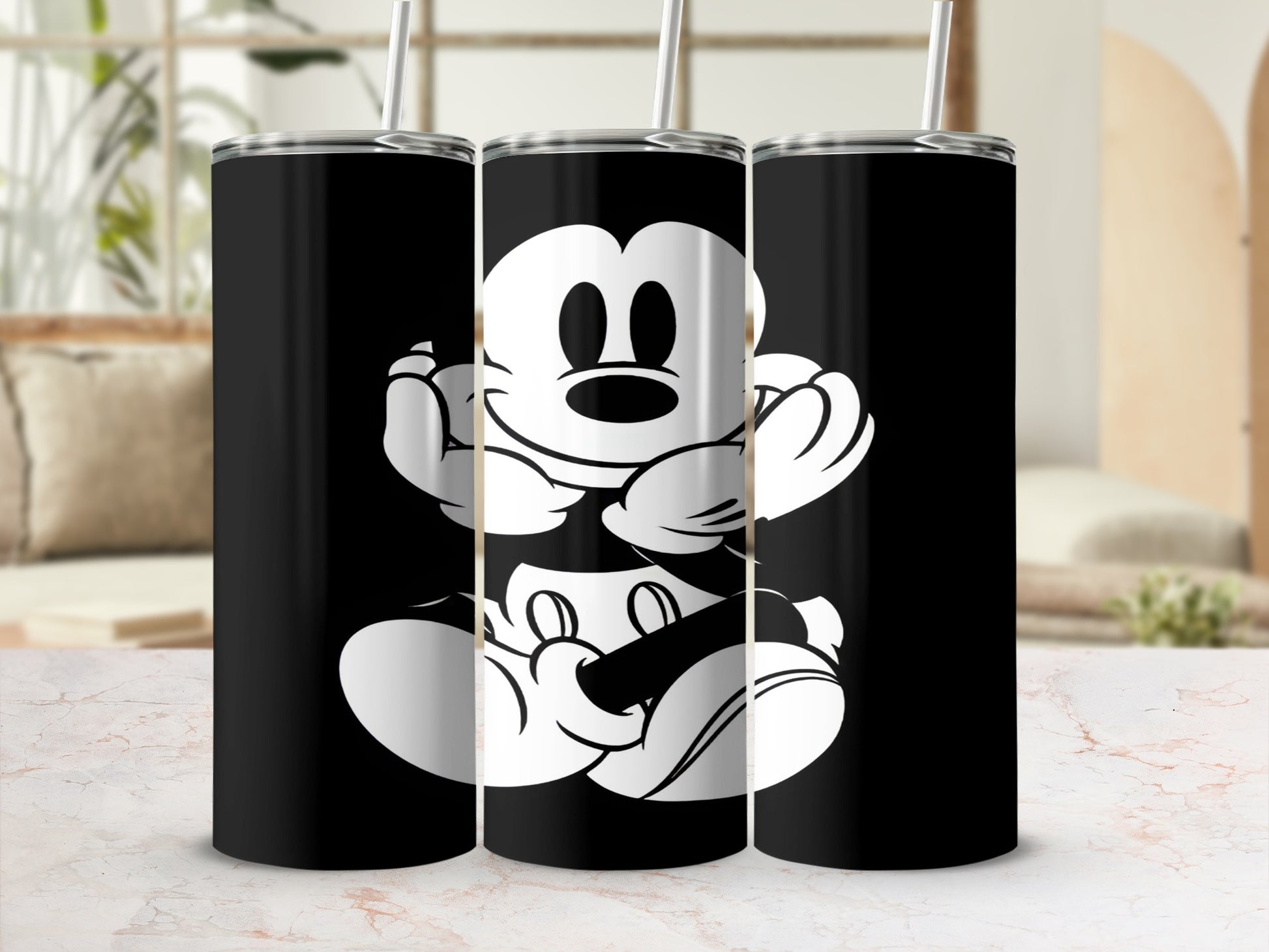 Black tumbler with white Mickey Mouse design and straw.