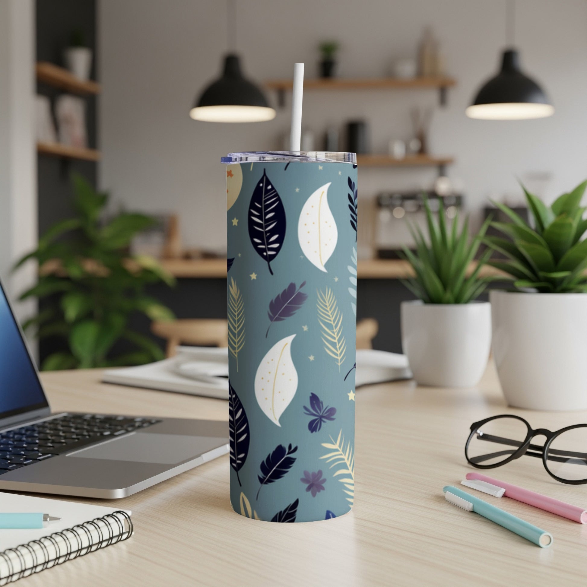 Dark blue tumbler with white, yellow, and purple leaf and butterfly pattern.