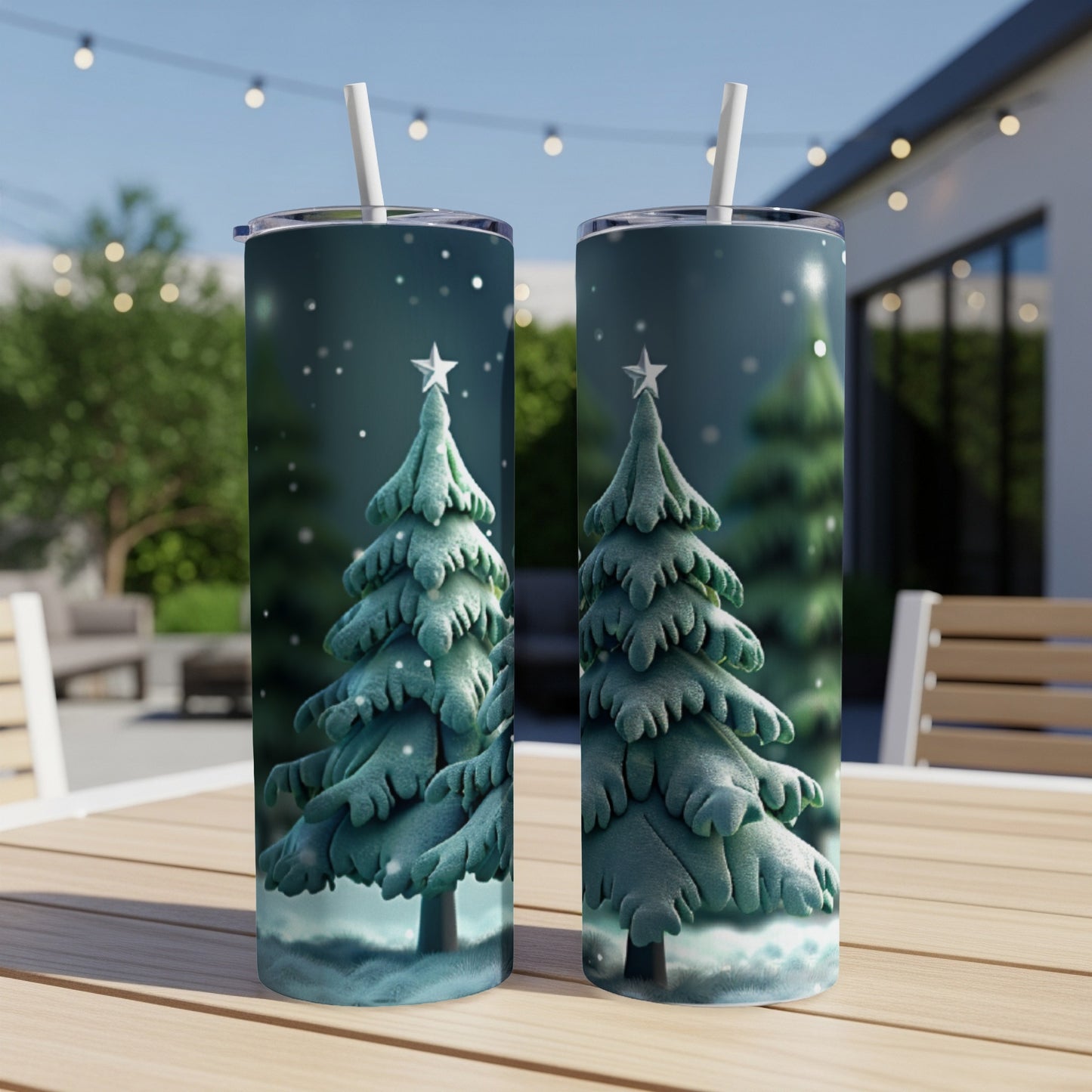 Two tumblers featuring a frosted Christmas tree design on an outdoor patio.