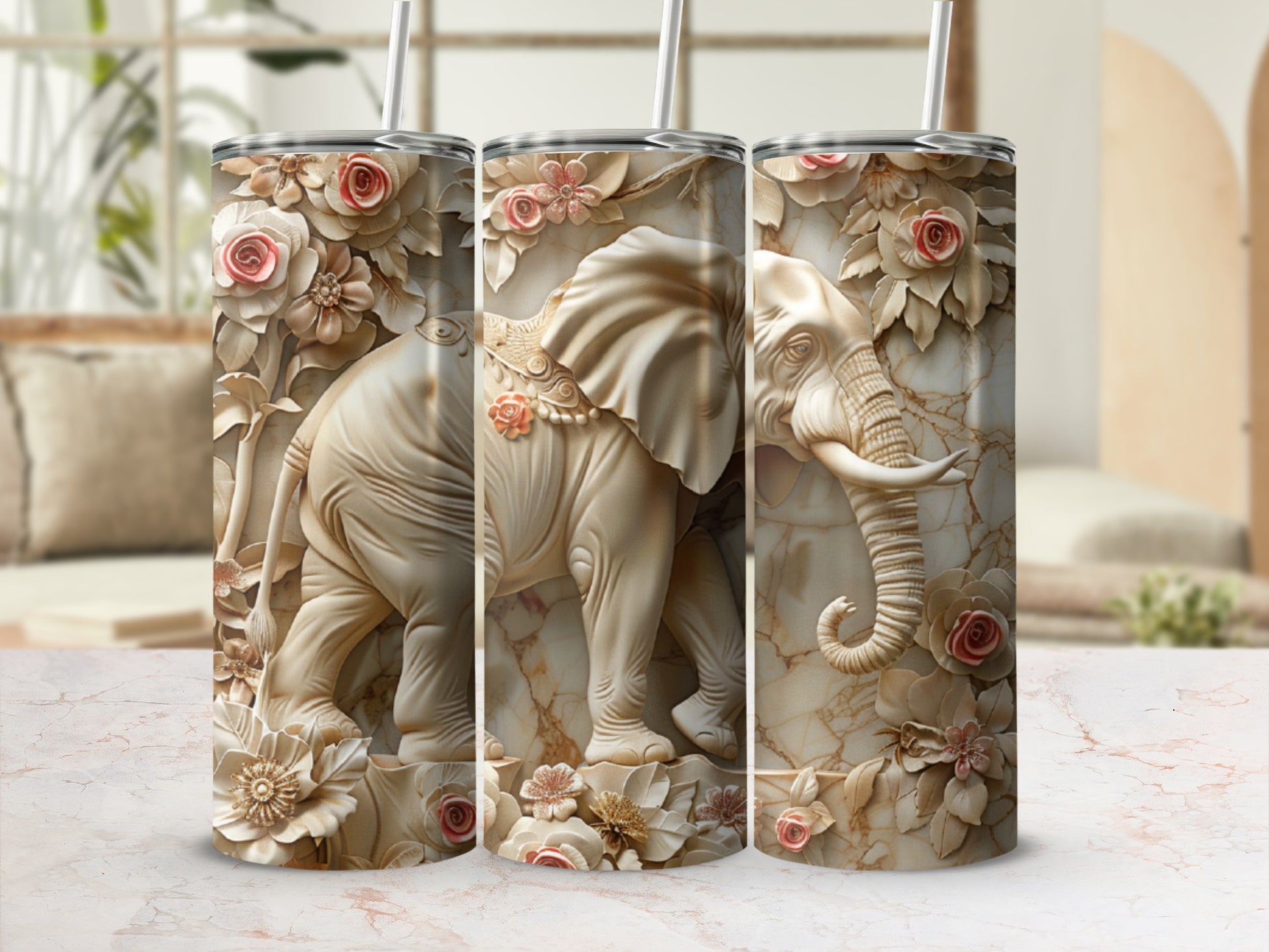 Three tumblers featuring a detailed elephant relief design with floral accents.