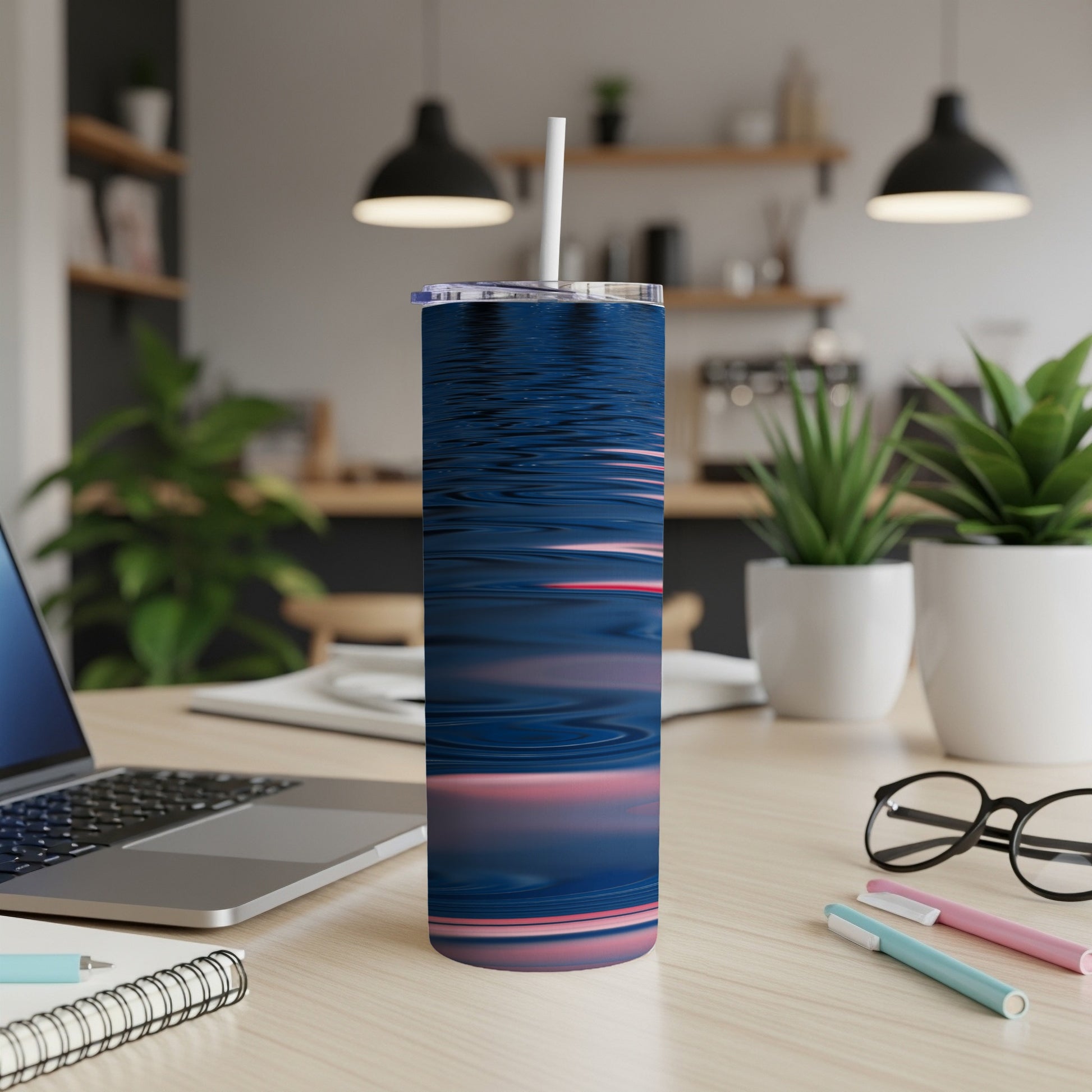 Blue and pink abstract wave pattern on a tumbler with a straw.