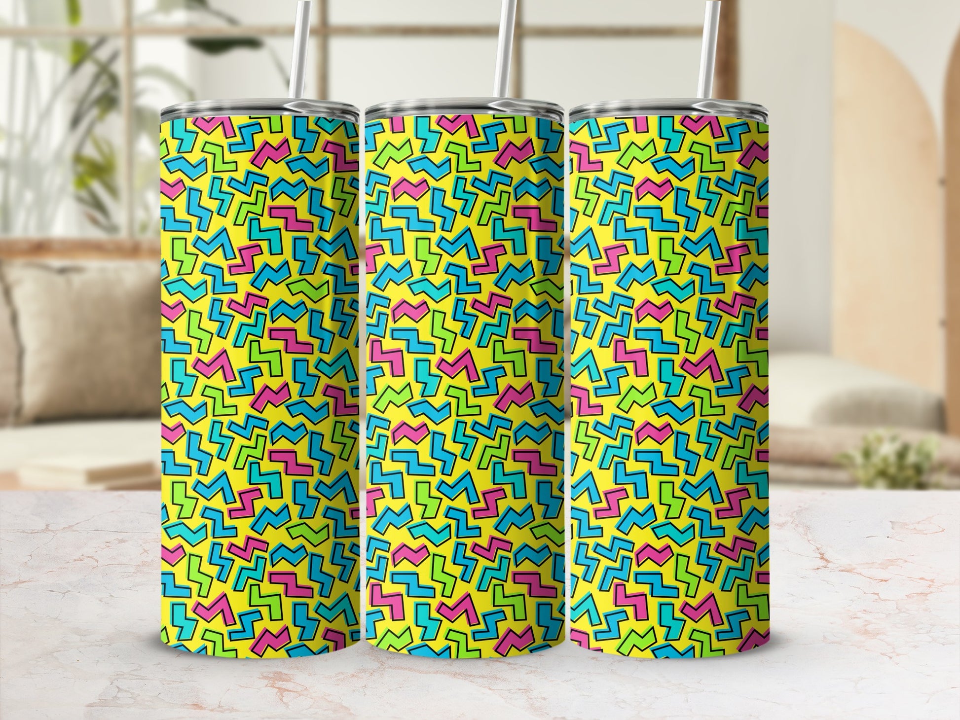 Three tumblers with a yellow background and scattered geometric shapes in pink, blue, and green.