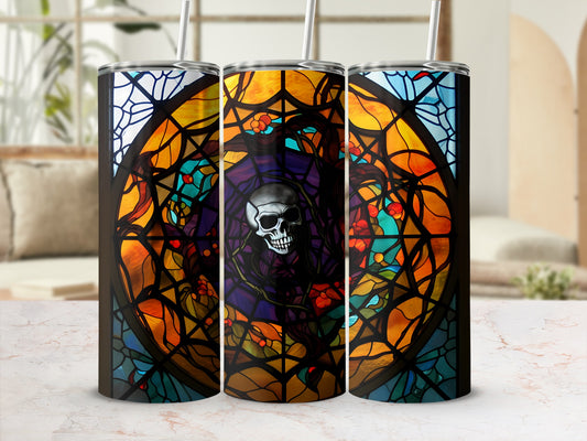 Three tumblers with a stained-glass skull design in front of a blurred room.
