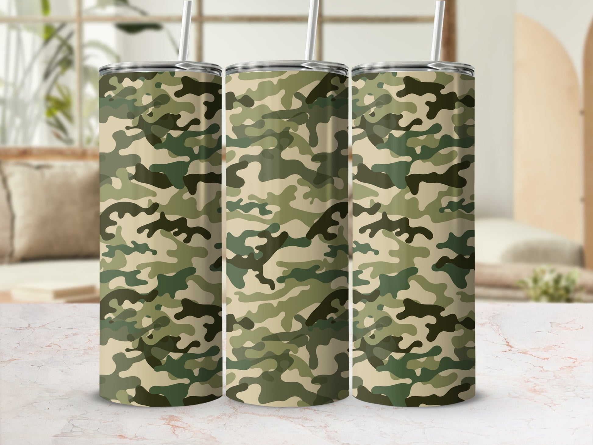 Three tumblers with a camouflage pattern and straws are shown.