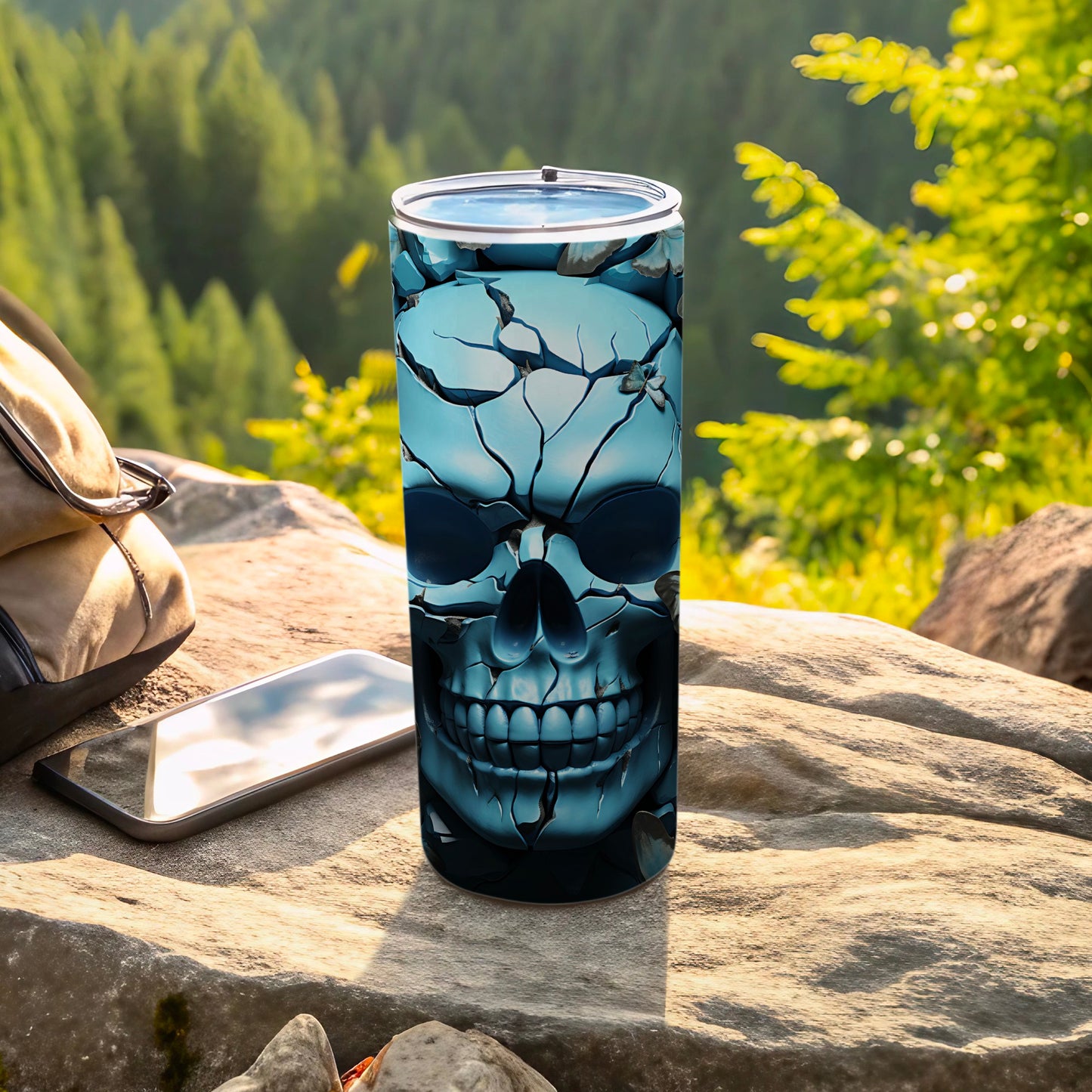 Skull tumbler on rock with phone and backpack, forest background.