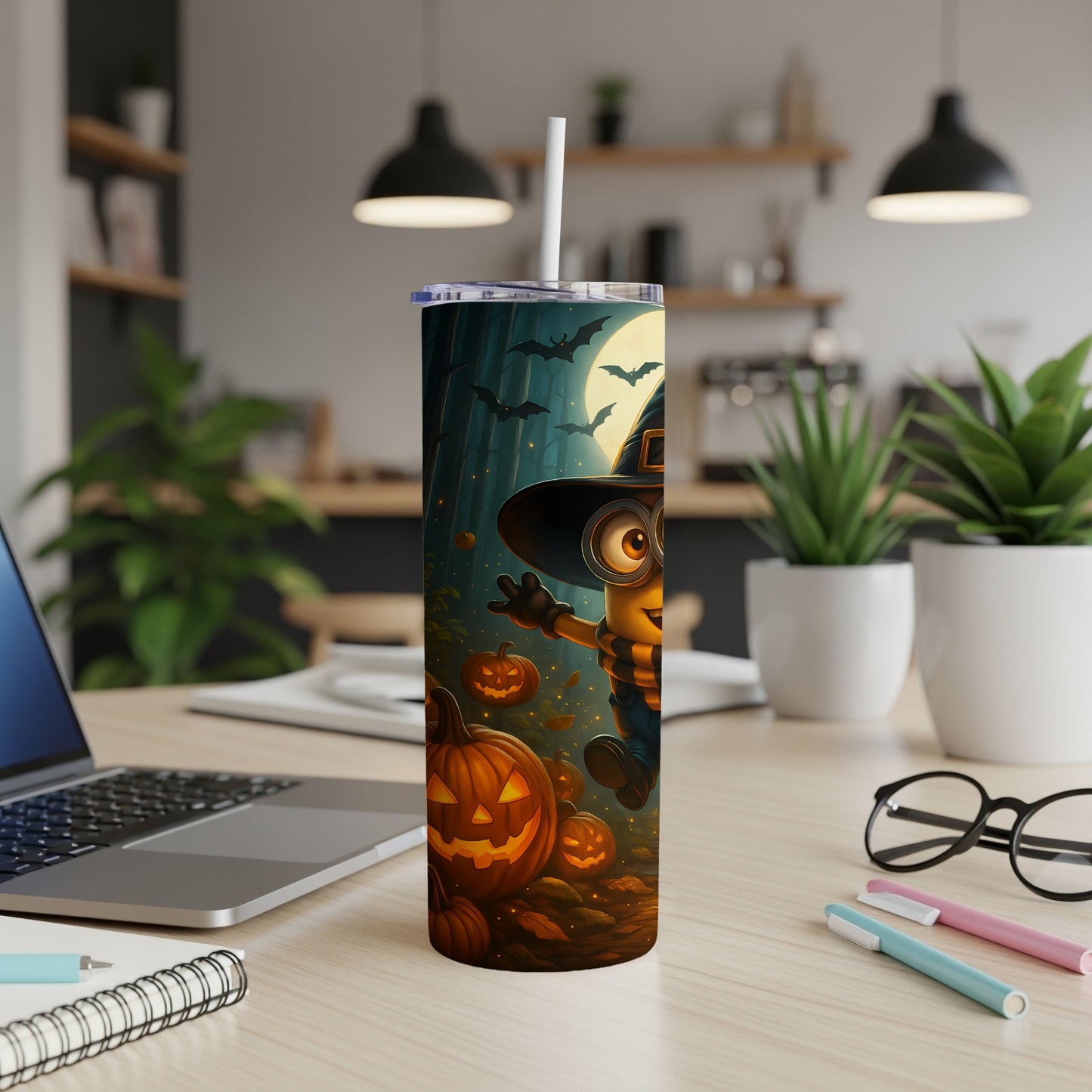 Minion in witch hat with pumpkins and bats on Halloween-themed tumbler.