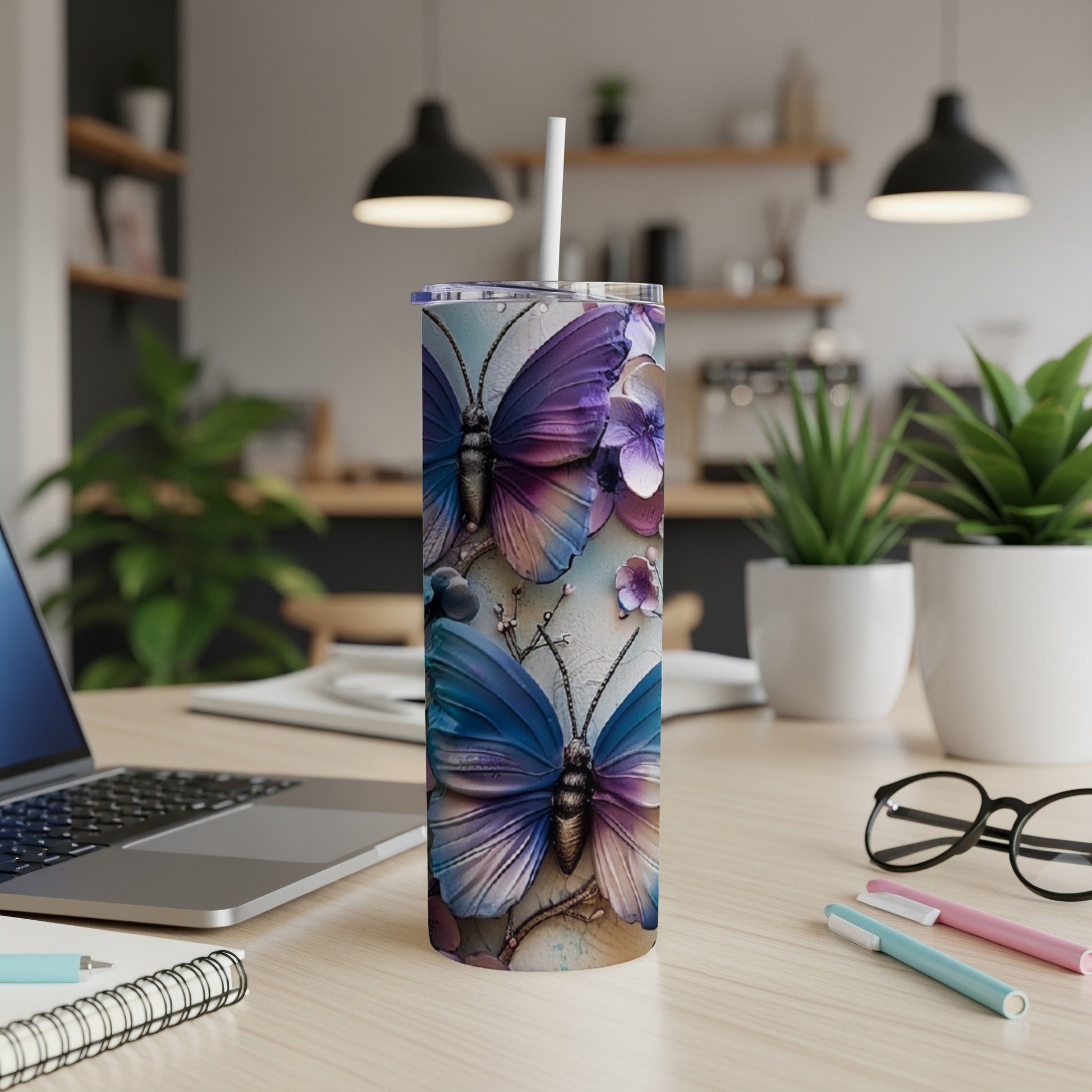 Two purple and blue butterflies with floral accents on a tumbler.