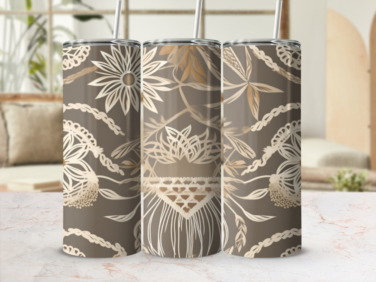 Three tumblers with floral and boho macrame patterns on a marble surface.