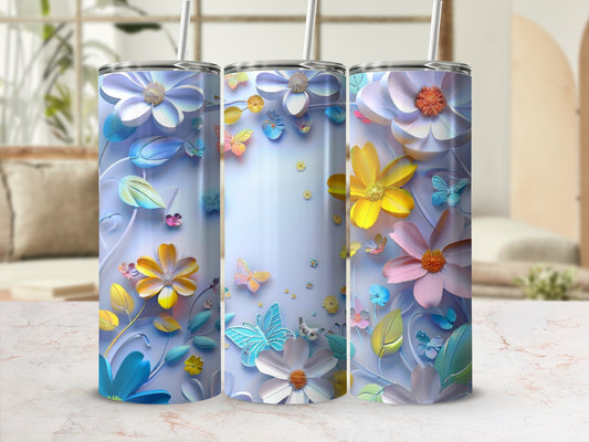 Three floral tumblers with butterflies on a marble surface.