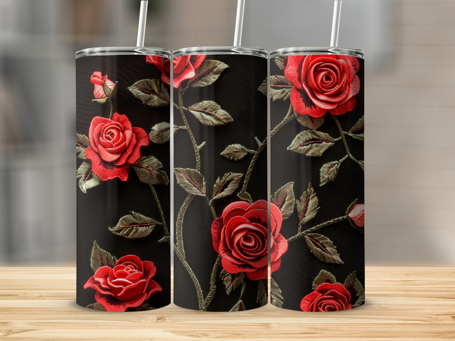Three tumblers with red rose embroidery design on a dark background.