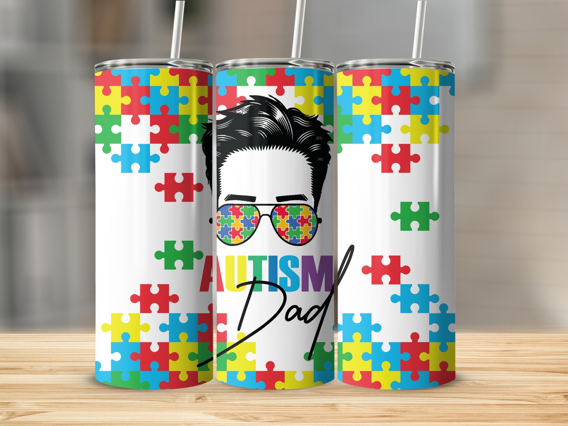 Tumbler with colorful puzzle pieces and "Autism Dad" text.