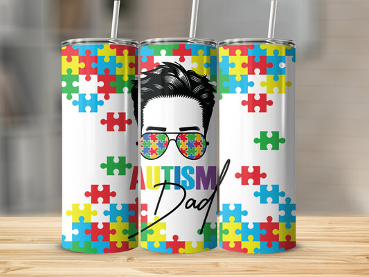 Tumbler with colorful puzzle pieces and "Autism Dad" text.