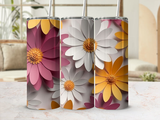 Three tumblers with daisy floral patterns in pink, white, and yellow.