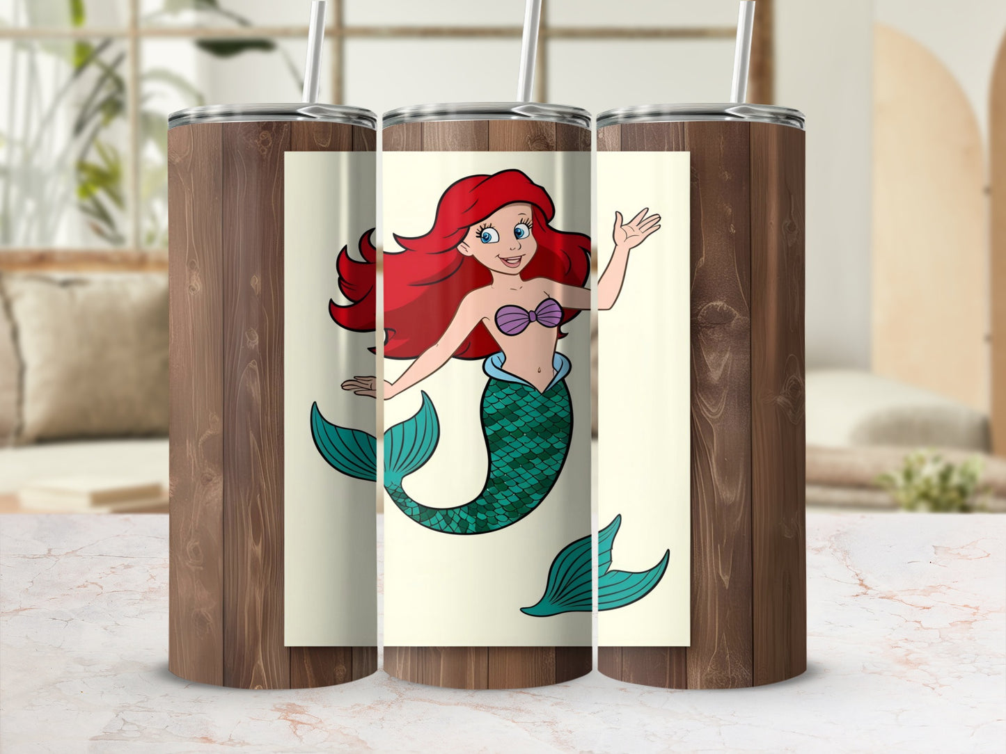 Ariel the mermaid with red hair and green tail on a tumbler.