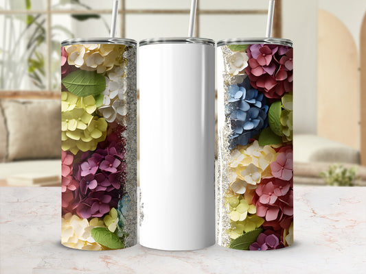 White tumbler with colorful floral hydrangea design and straw.