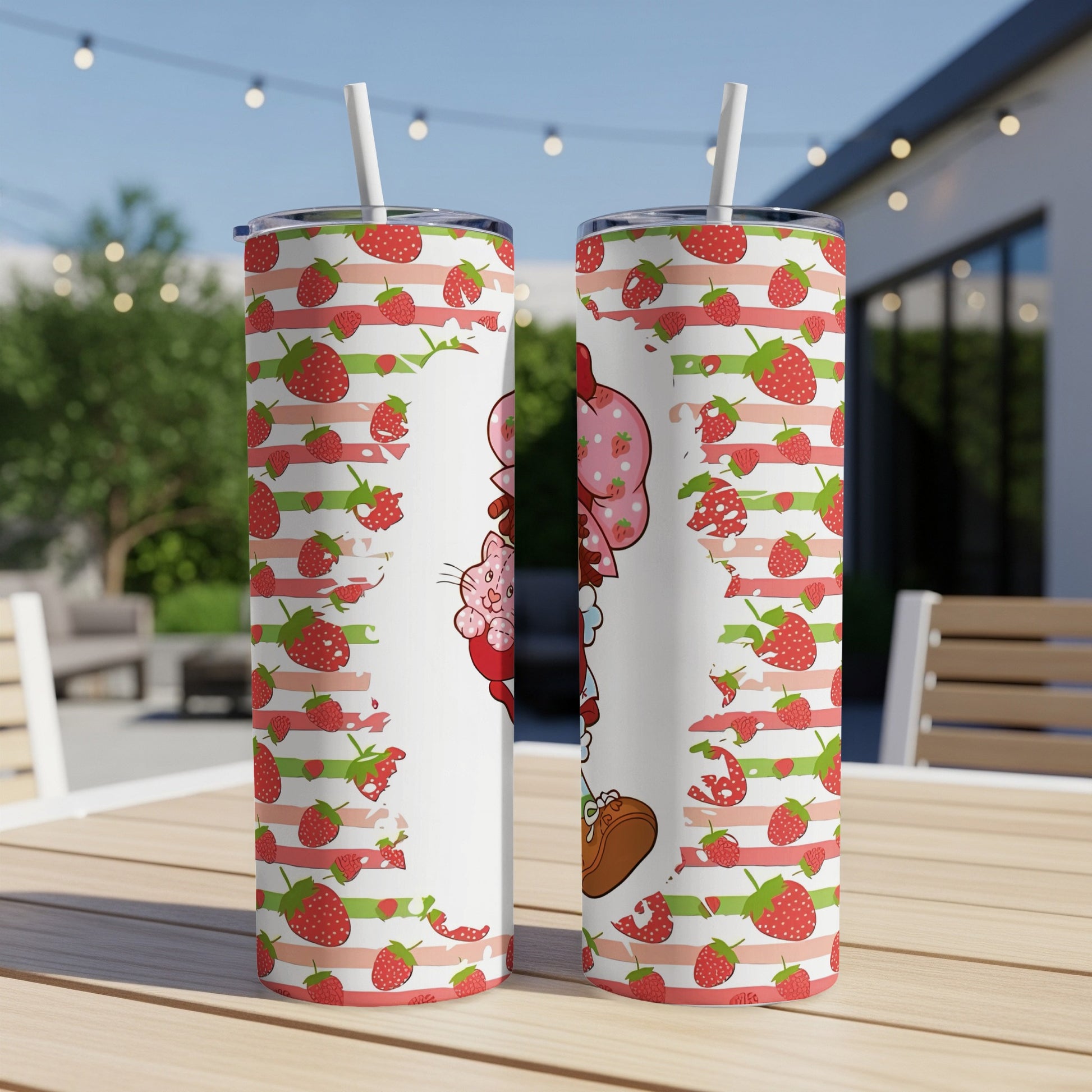 Strawberry Shortcake character with strawberries on a white tumbler with straws.