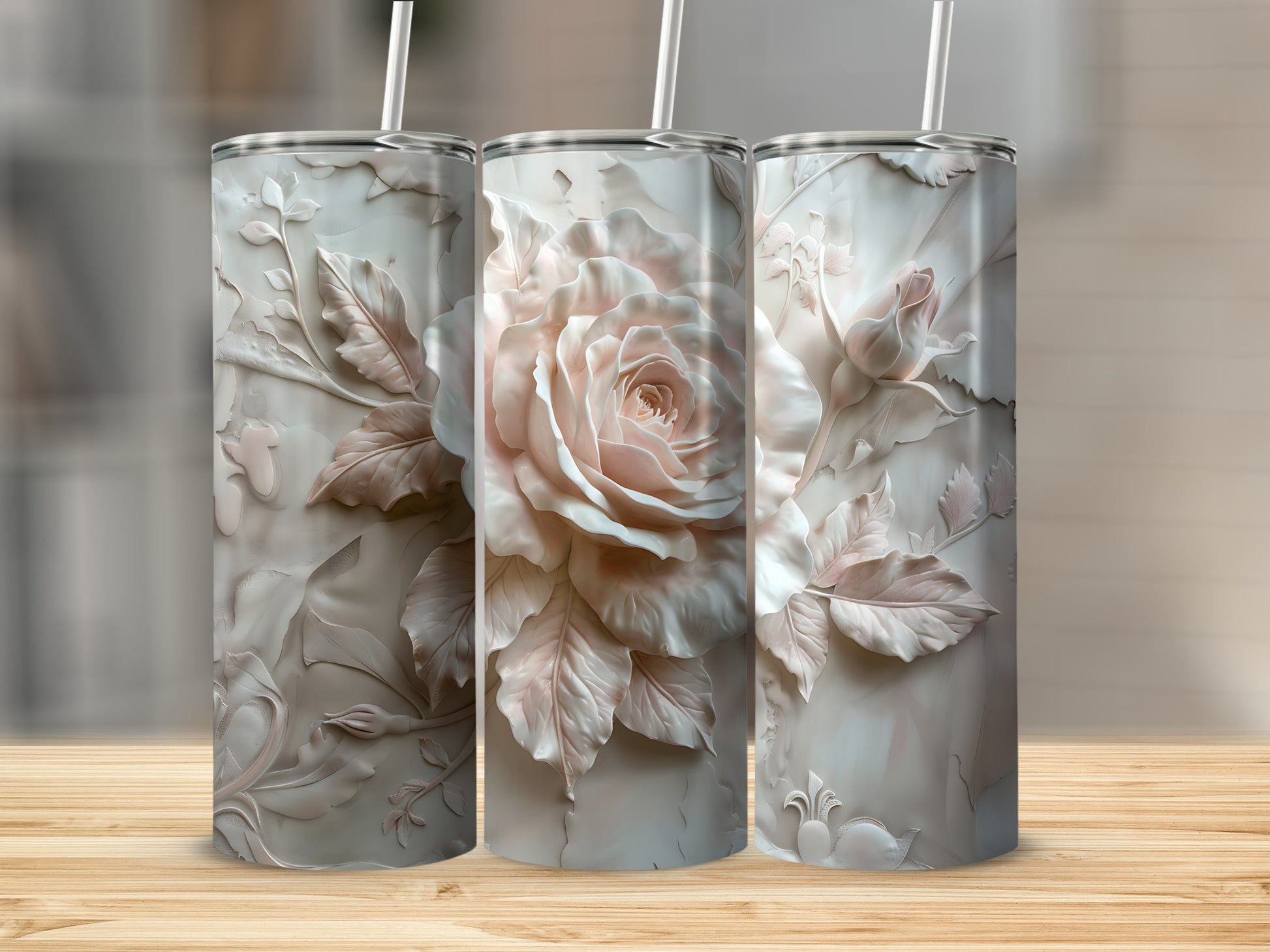 Three textured tumblers with embossed rose designs and straws.