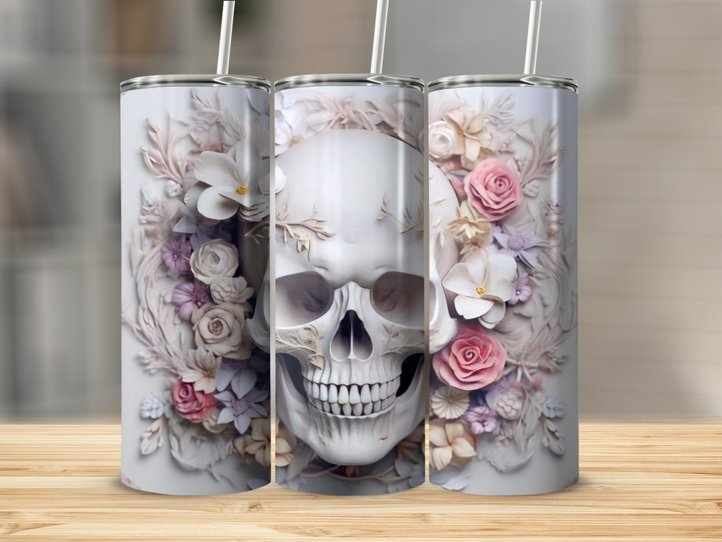 White tumbler with skull and floral decoration and straw.