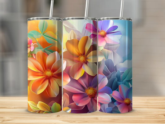 Three tumblers with colorful floral designs arranged on a wooden surface.