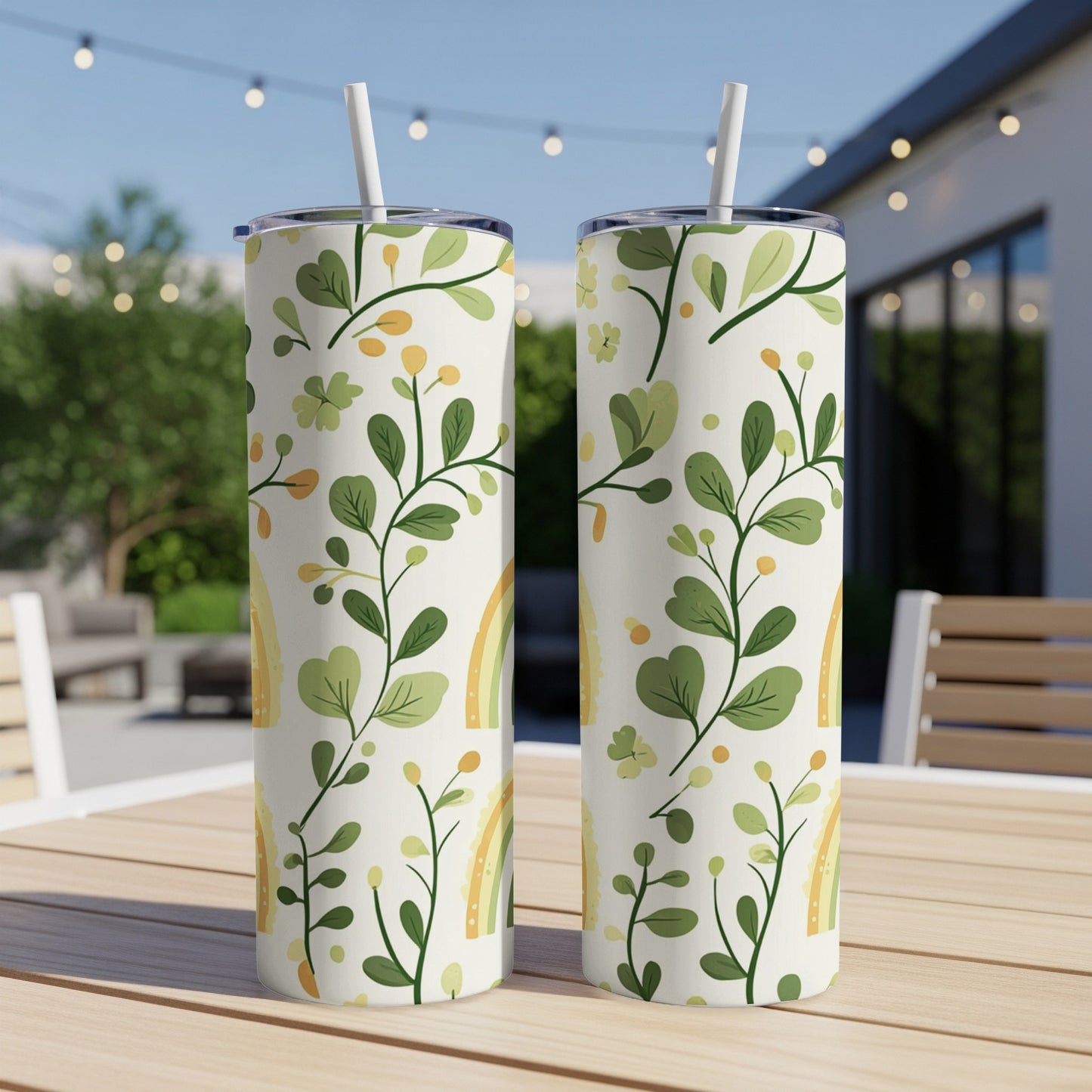 Two white tumblers with a green botanical pattern and subtle rainbow accents.