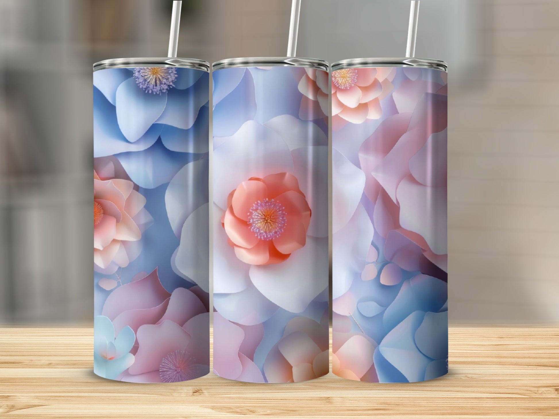 Three tumblers with pastel floral patterns and silver straws.
