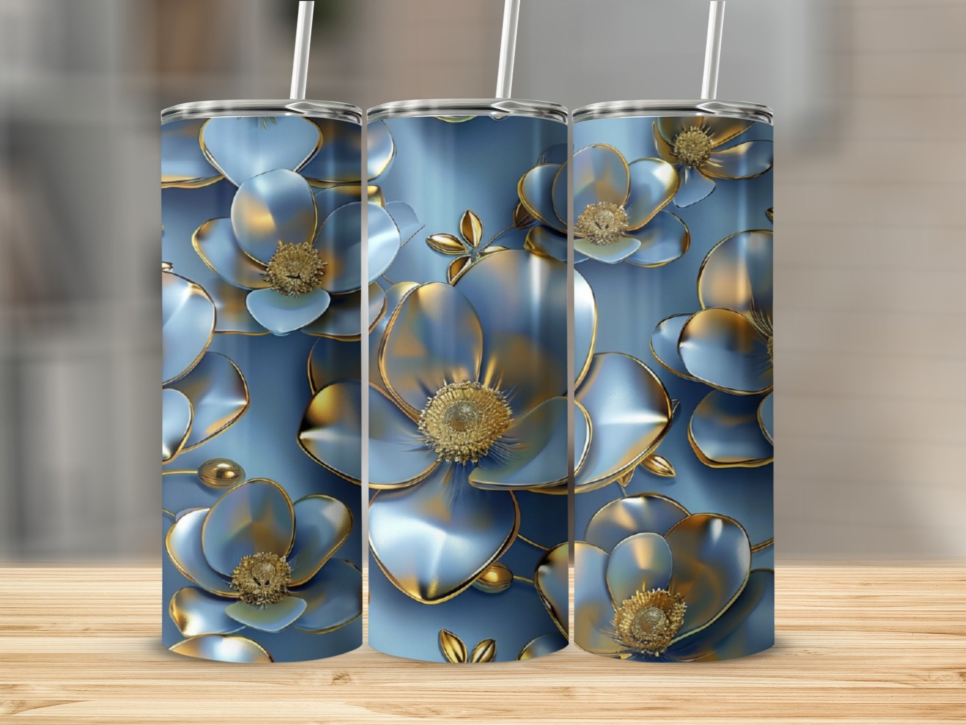 Blue and gold floral patterned tumblers with straws on a wooden surface.
