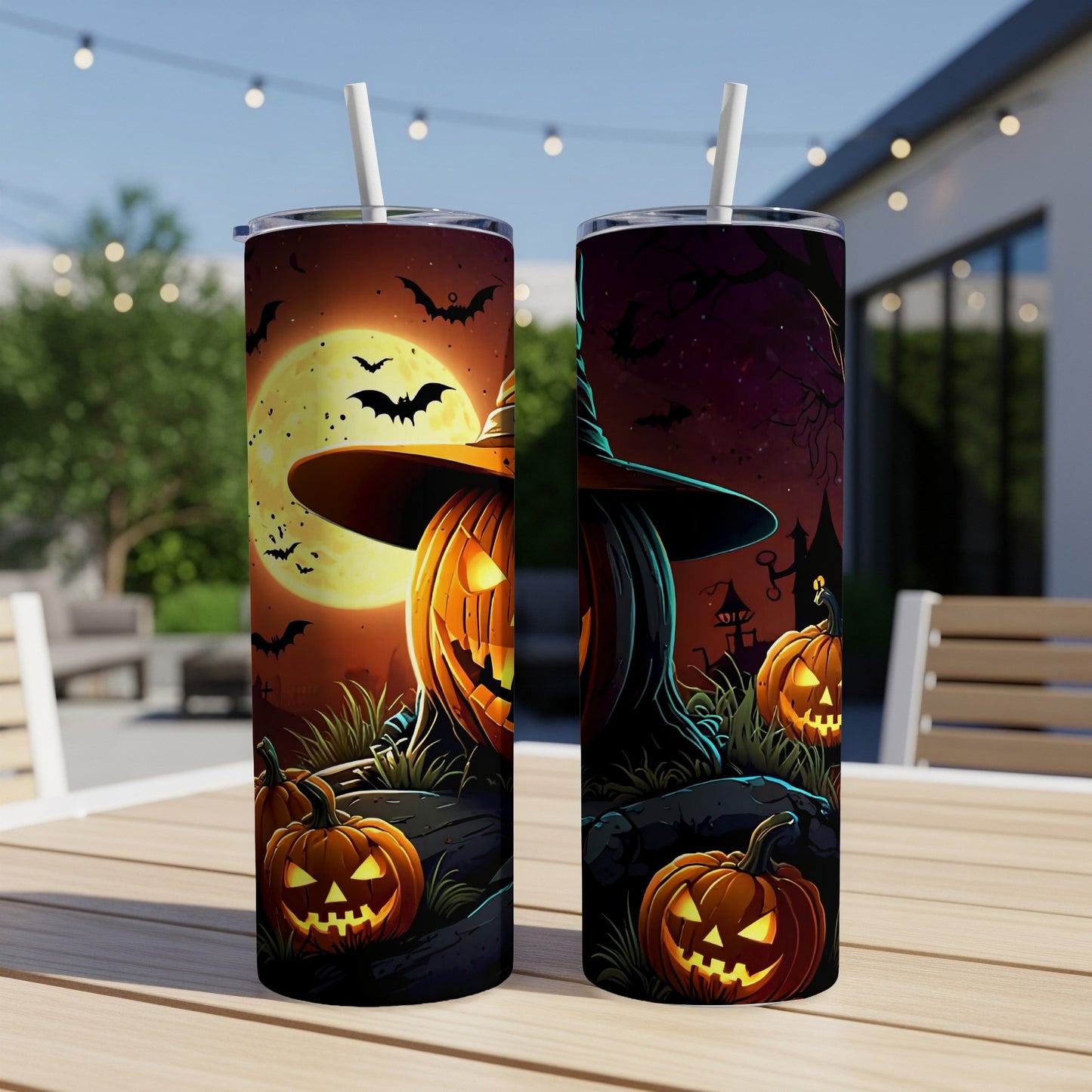 Halloween tumblers with glowing jack-o'-lanterns, bats, and moon on outdoor table.