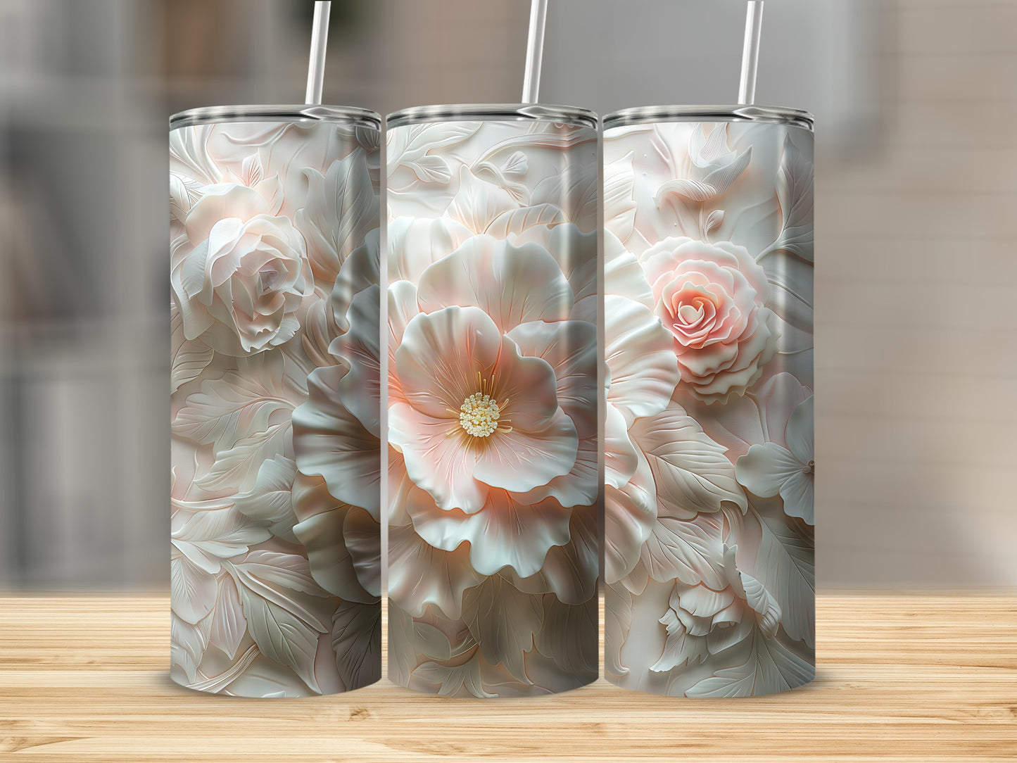 Three tall tumblers with delicate rose and floral embossed designs.