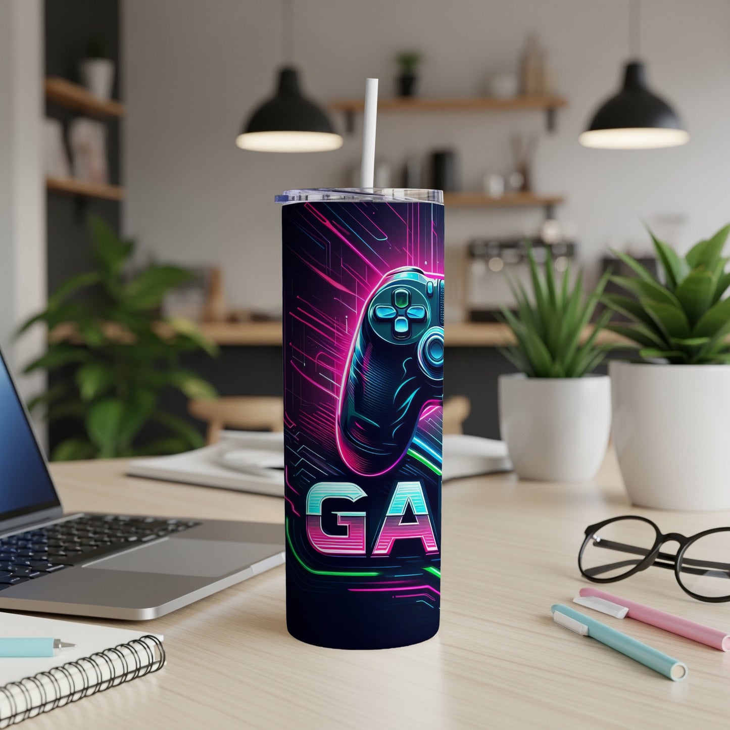 Gaming controller design on a navy blue tumbler with straw.