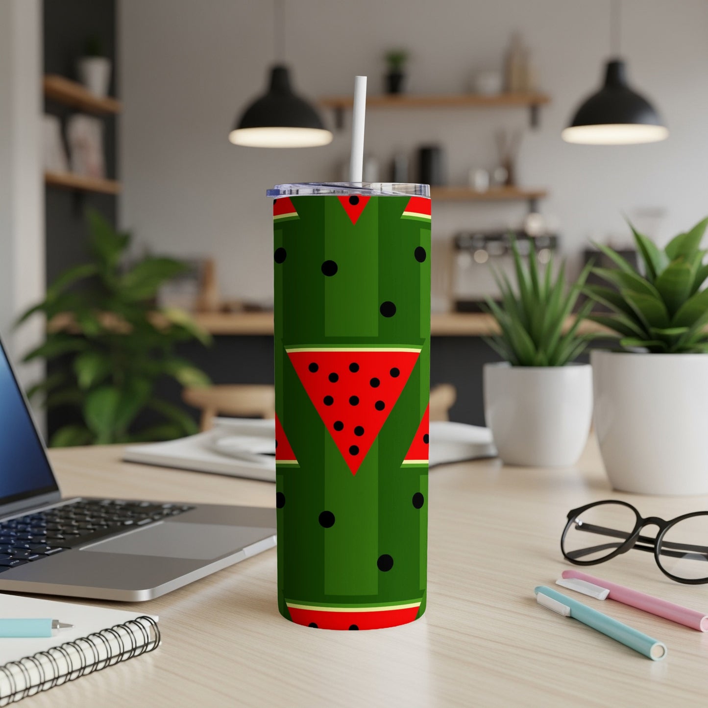 Green tumbler with repeating watermelon slice pattern and black dots.