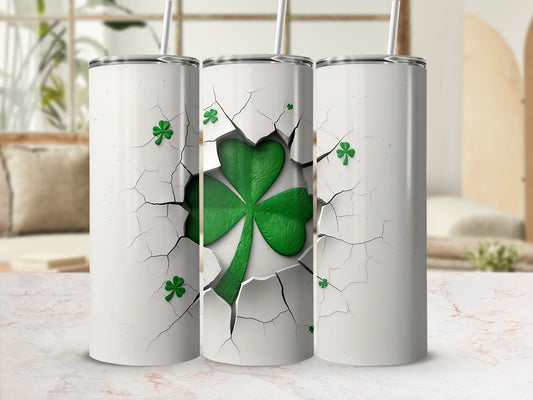 White tumbler with cracked surface revealing green shamrocks inside.
