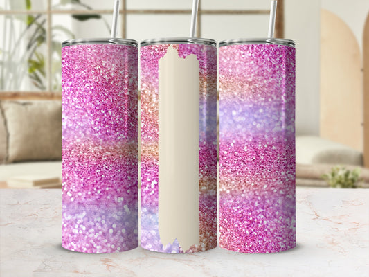 Pink, purple, and gold glitter tumbler with straw, displayed on a marble surface.