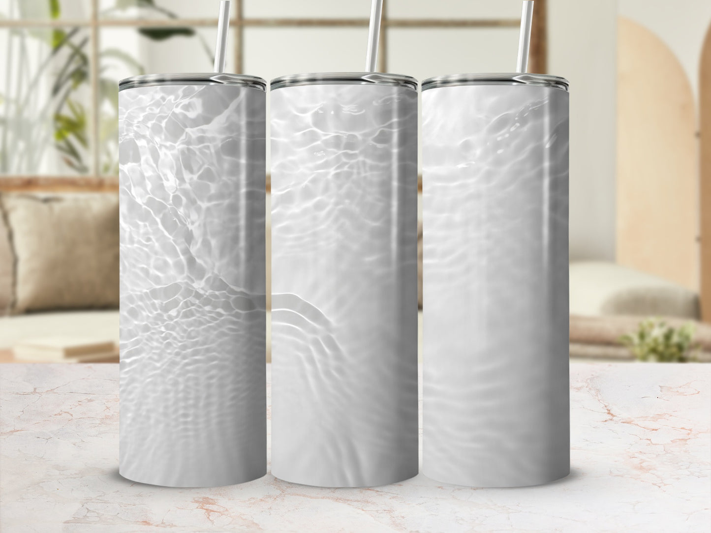 Three white tumblers with rippling water texture and straw.