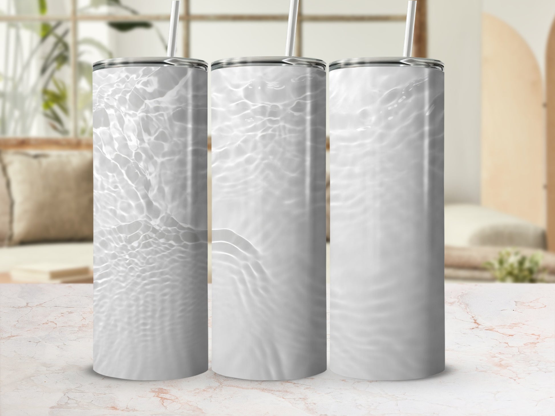 Three white tumblers with rippling water texture and straw.