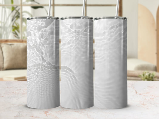 Three white tumblers with rippling water texture and straw.