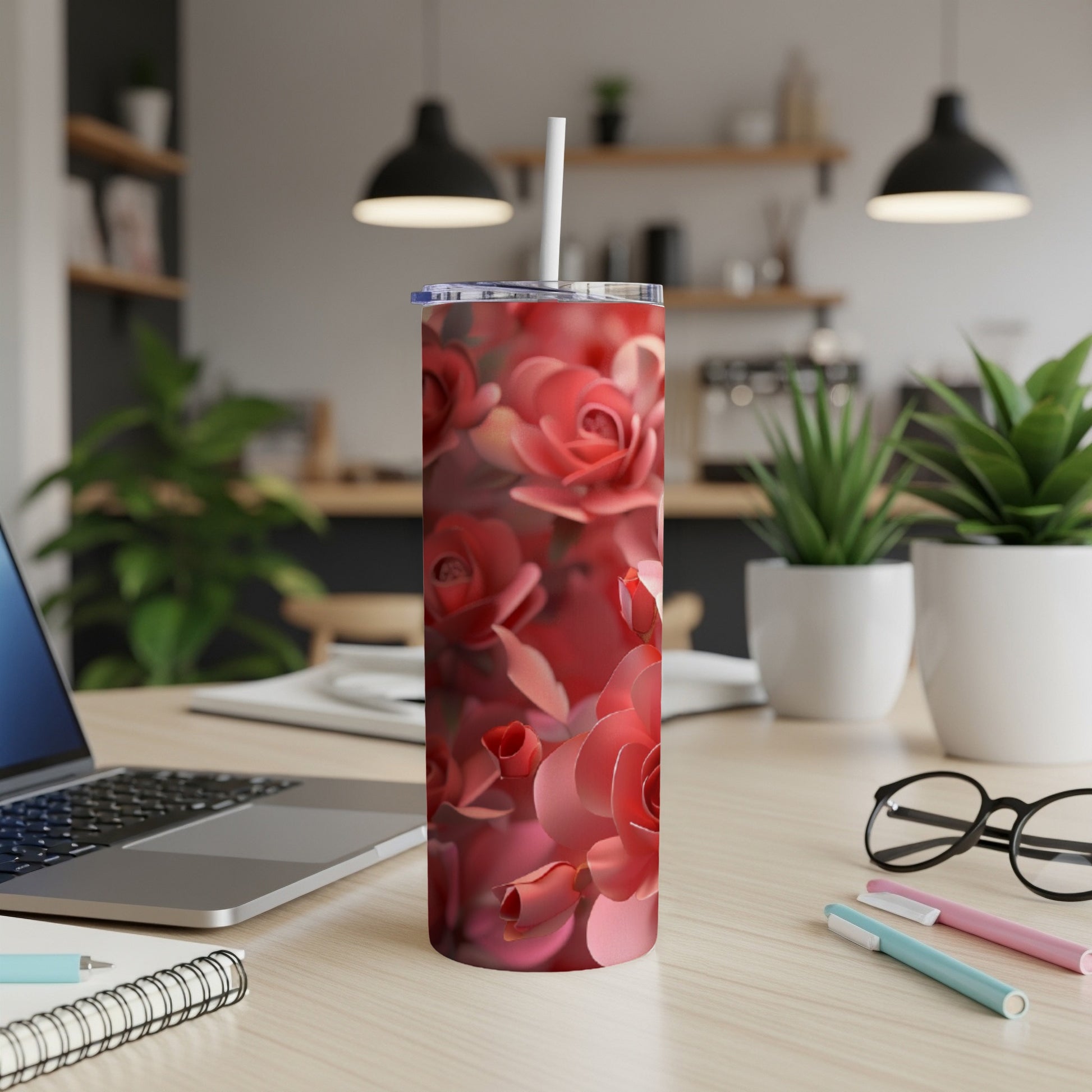 Pink roses cover a stainless steel tumbler with a straw.