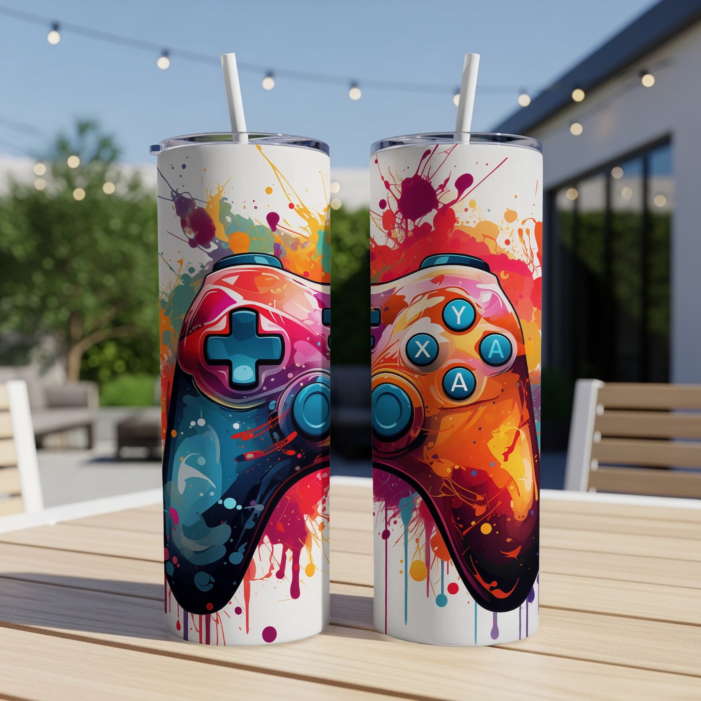 Two colorful gaming controllers with paint splatters on white tumblers.