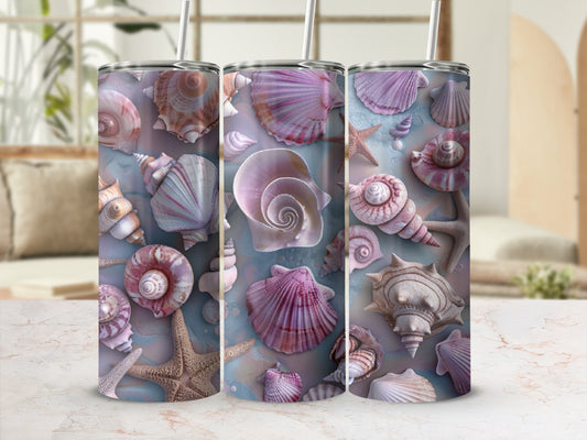 Three tumblers featuring seashell and starfish designs on a marble surface.