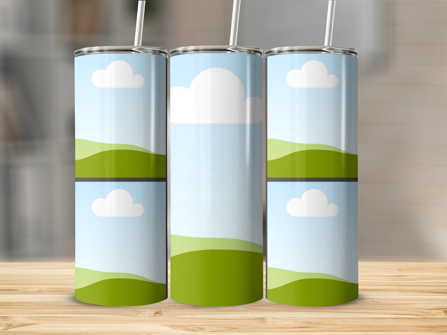 Three tumblers with sky and rolling green hill designs and straws.