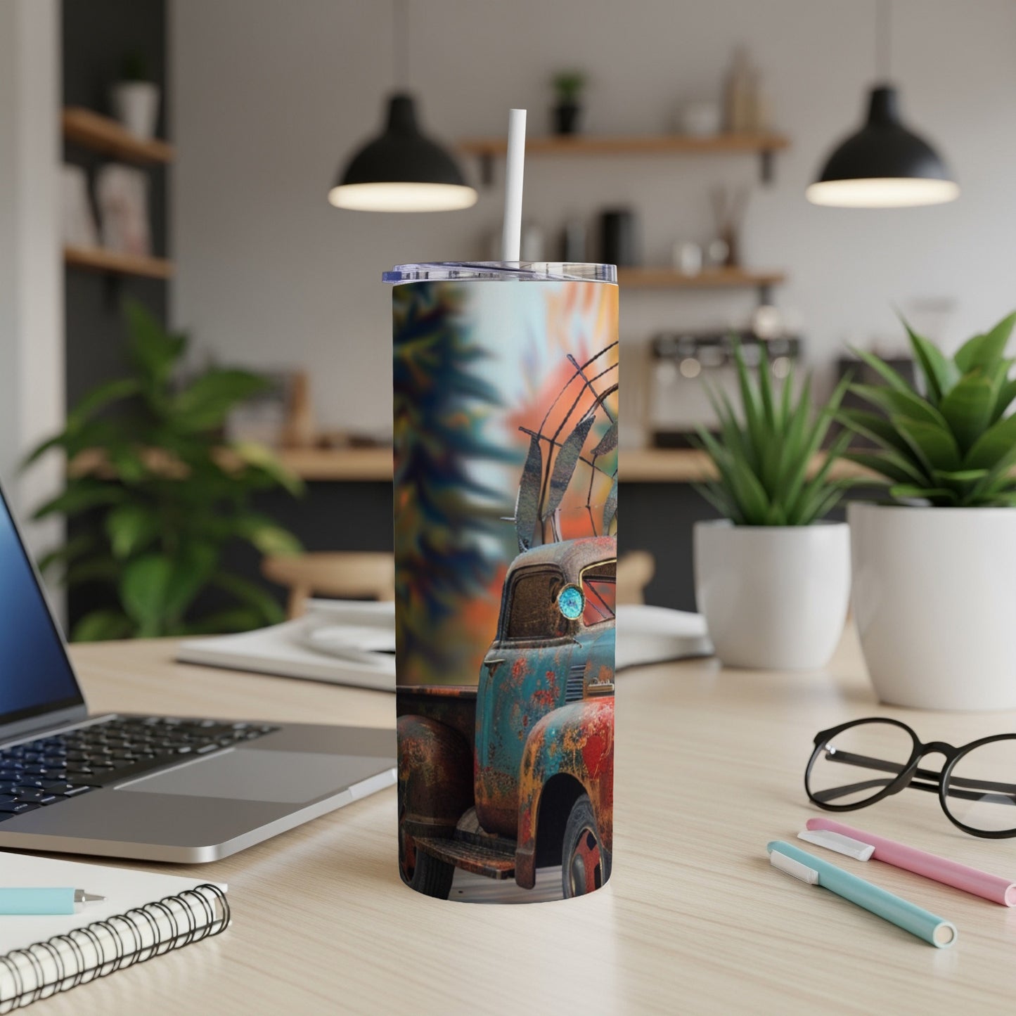 Rustic teal and orange truck with antlers on tumbler, shown on a desk.