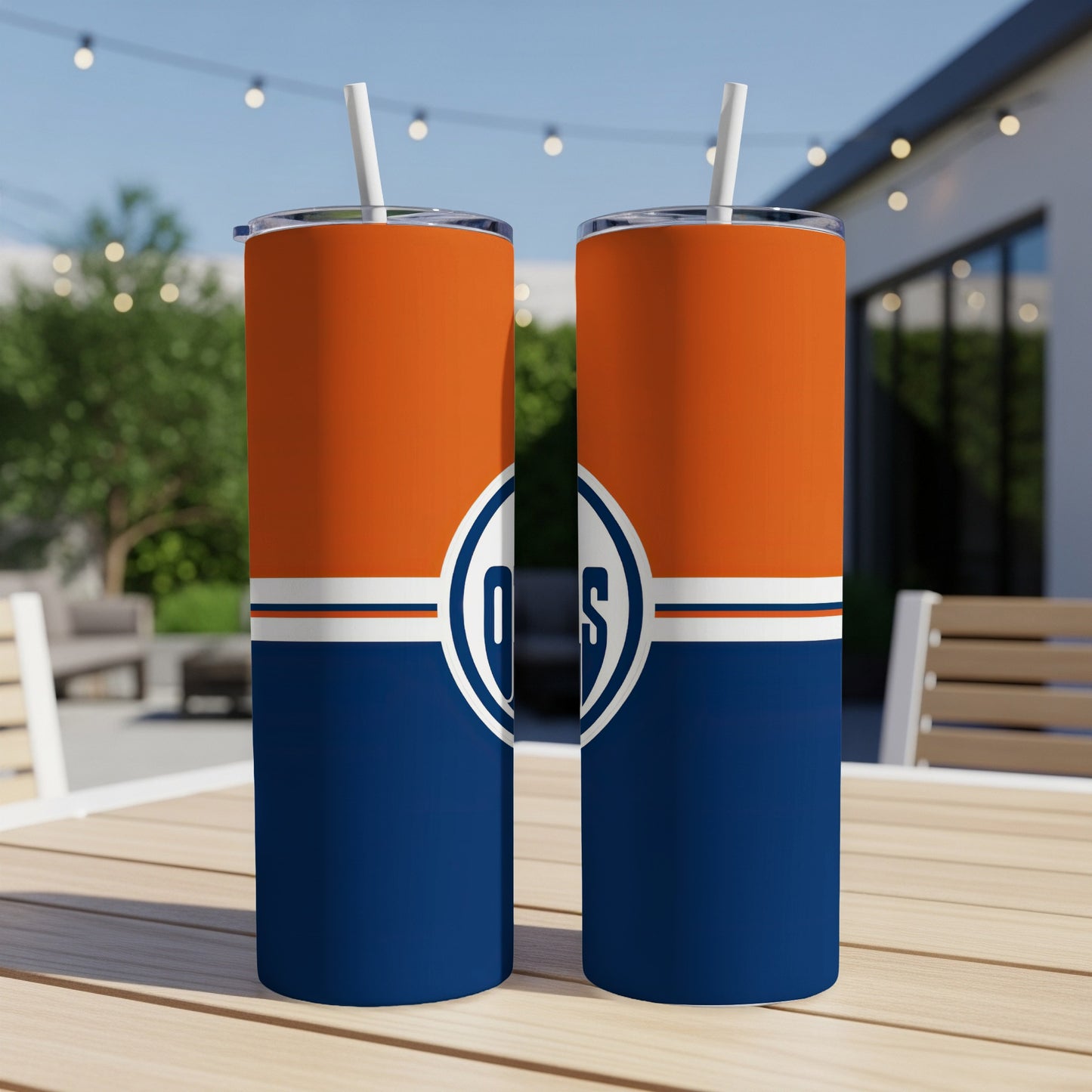 Two Edmonton Oilers tumblers with straws in orange, white, and navy blue.