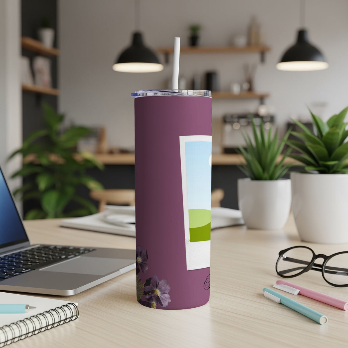 Purple tumbler with white straw, featuring a framed landscape and floral design.