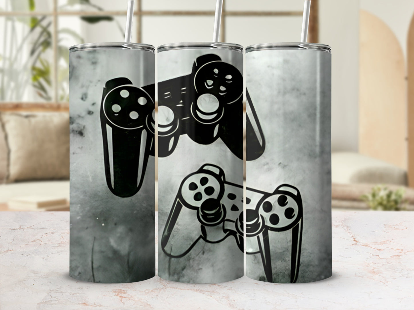 Two black video game controllers with a grunge texture wrap a silver tumbler with a straw.