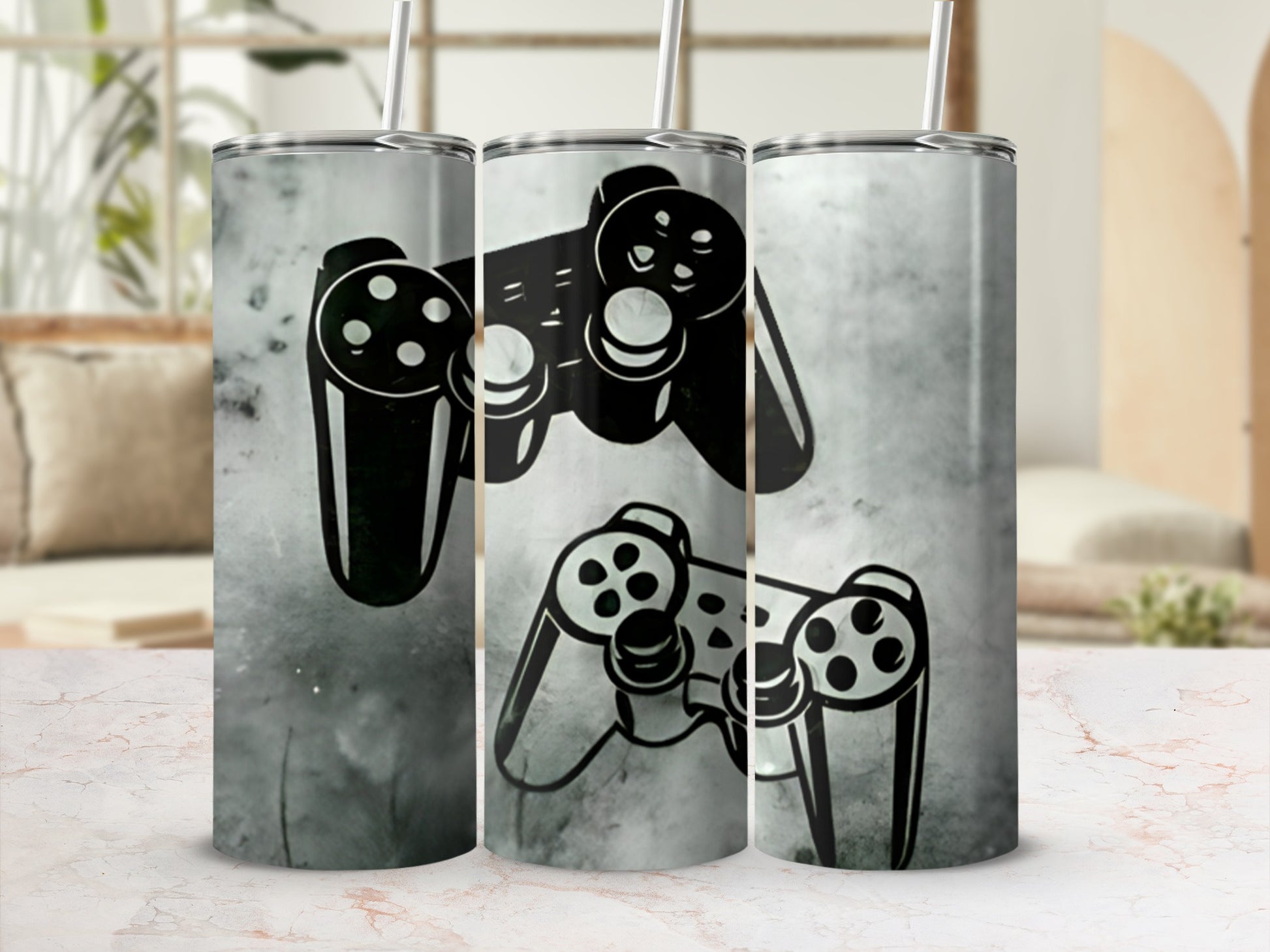 Two black video game controllers with a grunge texture wrap a silver tumbler with a straw.
